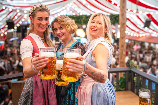 Music, Ma&szlig;kr&uuml;ge, and Bavarian joy fill the beer tent as friends celebrate together. Oktoberfest Munich, G&auml;ubodenvolksfest Straubing, Maidult Regensburg, Germany