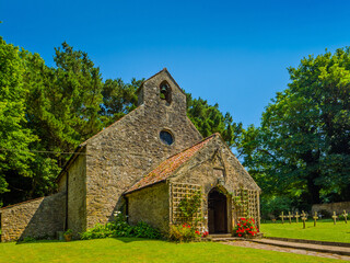 St David's Church surrounded by greenery (Caldey Island, Tenby, Wales, United Kingdom)
