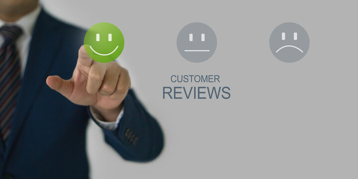 A businessman in smart blue suit and tie pointing finger at smile face icon to give satisfaction in service, rating very impressed. - Powered by Adobe