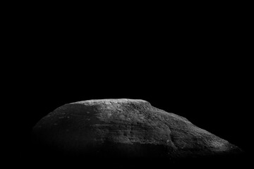 Stone podium on dark black background..