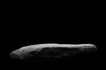 Stone podium on dark black background..