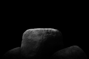 Stone podium on dark black background..