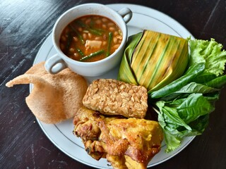 Complete Chicken Timbel Rice Meal with Tofu, Tempeh, Sayur Asem and Fresh Vegetables
