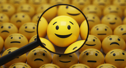 A magnifying glass focusing on a happy emoji among many other emojis with various expressions shown