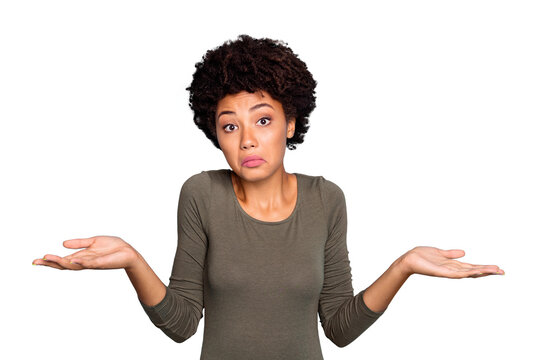 I dont care! Portrait of doubtful negative curly hair afro american girl cant choose answer solve trouble shrug shoulders hold hands hesitate wear beautiful outfit isolated blue color background