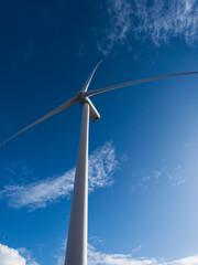 Wind turbine, view up tower to nacelle with rotor blades and hub.