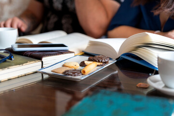 Writers meeting discussing literature, enjoying coffee and cookies