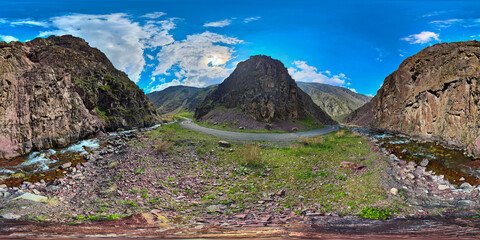 Full Spherical panorama of a mountain ravine with dirt road and river turn at springtime day in equirectangular projection