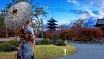 Japanese Woman in  Traditional Kimono Dress at Toji Temple in Kyoto, Japan with beautiful garden and autumn foliage