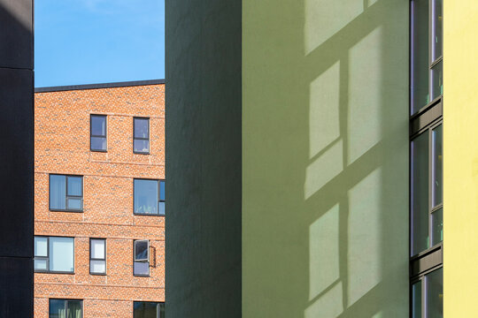 Abstract composition of green building facade, bold color blocks, geometric shapes and windows, minimalist modern architecture, urban details.