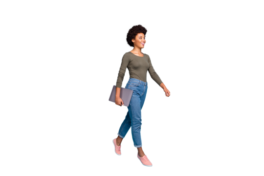 Full length photo of positive cheerful afro american girl hold her netbook go university for education learning wear casual style outfit denim jeans pink sneakers isolated blue color background