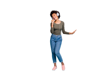 Full length body size photo of excited cheerful fun positive cute girlfriend singing into imaginary microphone wearing jeans denim green sweater dancing isolated over vivid blue color background