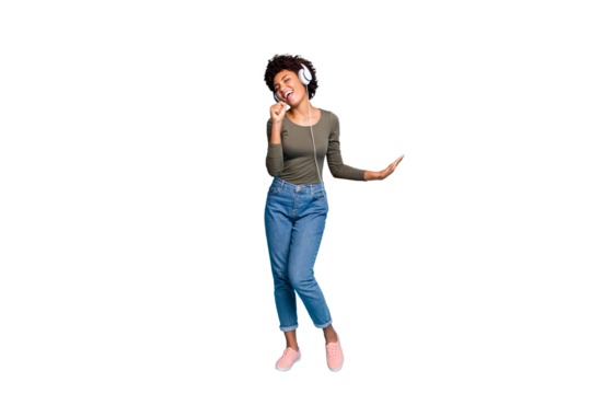 Full length body size photo of excited cheerful fun positive cute girlfriend singing into imaginary microphone wearing jeans denim green sweater dancing isolated over vivid blue color background