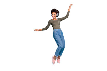 Full body photo of cheerful funny mulatto girl have free time listen music on her headset dance...