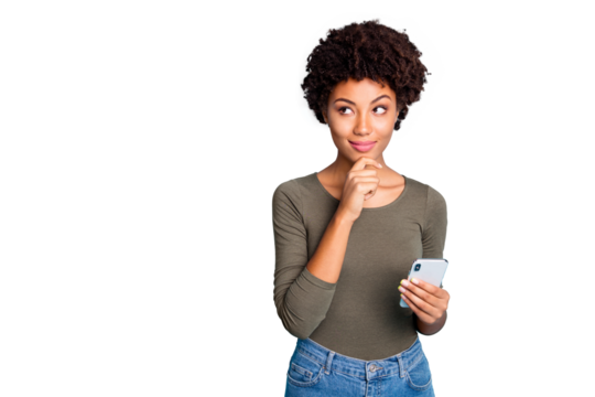 Photo of cunning smirking puzzled interested dark skinned youngster touching her chin in thought of what to post to her profile on social media wearing jeans denim isolated over color blue background