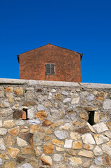 old house behind a stonewall in the village of Giglio Castello, Giglio island, Tuscany, Italy
