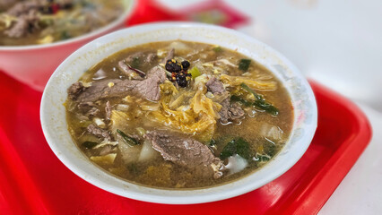 Stir-fried pickled cabbage and beef with hand-shaved noodles, served with fermented black bean chili sauce — Nanmen Market, featuring traditional Fujianese, Chinese and Taiwan