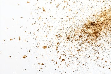 Gold powder explosion on white background. Small particles of gold scattered, creating a dynamic texture