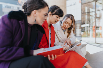 Three professionals are seen gathered outdoors, intently discussing notes and documents, signifying...