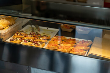Bruschetta with tomato in the shop window of a cozy cafe. Tasty food. Small business, food concept.