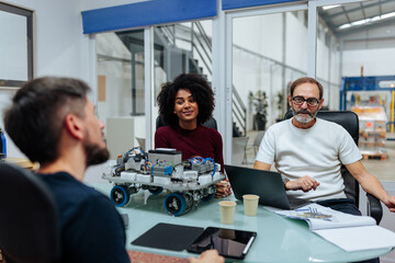 Engineers collaborating on robotics project in high-tech office