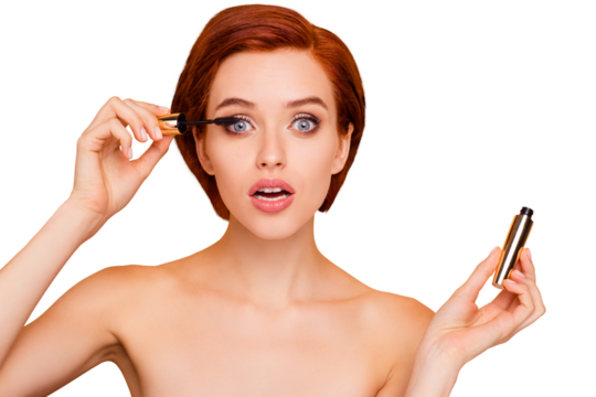 Close-up portrait of nice dreamy lovely sweet attractive glamorous positive girl holding in hands applying black mascara isolated over beige pastel background