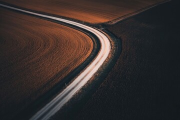 Winding Road Through Fields at Sunset