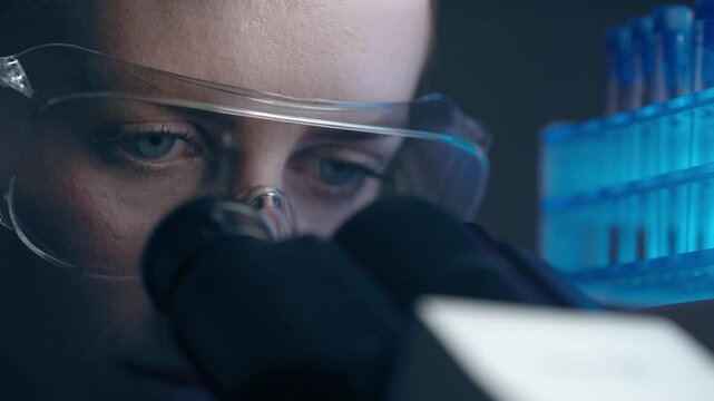 Female virologist scientist using microscope in laboratory. Biochemical and medical research. Pharmacist specialist working with lab equipment analyzing samples and searching for vaccine development - Powered by Adobe