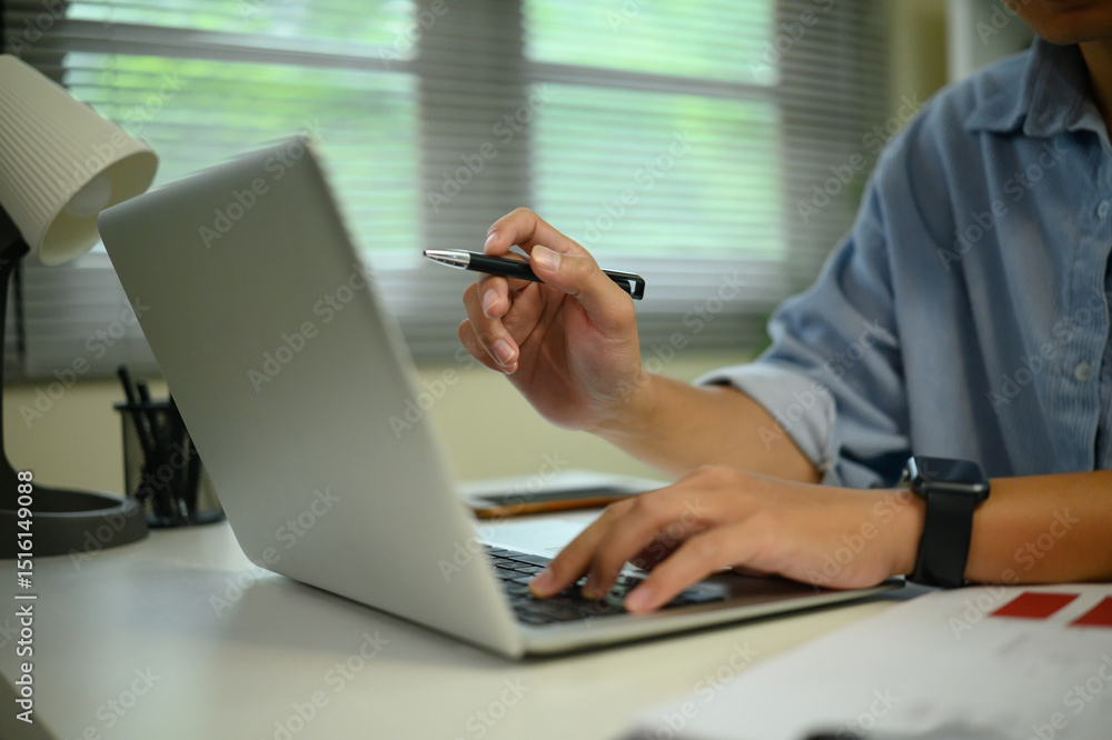 Poster close up of hands typing on a laptop while working in a modern workspace