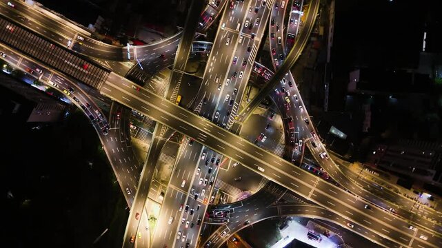 Aerial view rotating above traffic in a intersection, night in Shanghai, China