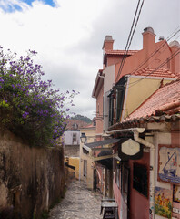A colourful street scene in Sintra, Portugal, with traditional tiled buildings, terracotta...