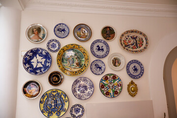 Elegant Spanish villa in Mallorca featuring a serene pool, Mediterranean tiles, chandeliers, and angel statues. Captures timeless charm and artistic architecture.