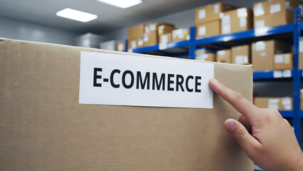 Top shot of a hand placing a e commerce label sticker on a cardboard shipping box.tariffs with trad war