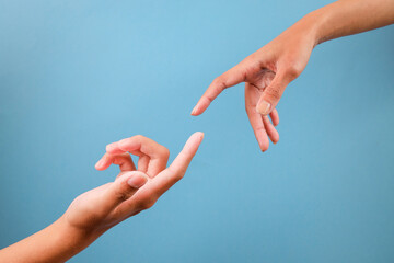 Two Fingers Almost Touching Isolated On Blue Background