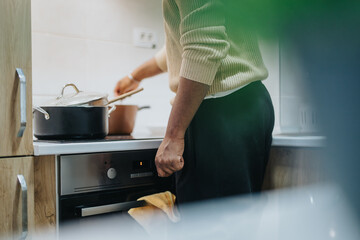 Image of a person preparing a meal in a modern kitchen, demonstrating the activity of cooking and...