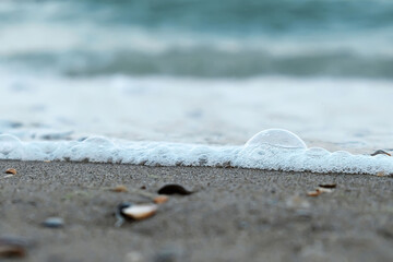 A large ball was created on the seashore by a wave. Selective focus. Close-up