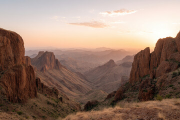 Naklejka premium breathtaking view of rocky desert landscape bathed in warm light showcasing harsh beauty of climate change