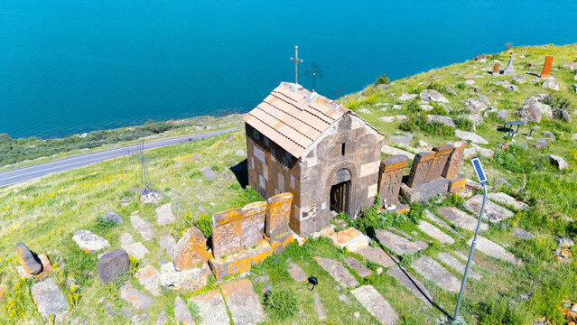 A small Church on top of a mountain. St. Hovhannes Church in Sevan taken with drone
