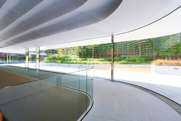 Empty corridor beside large glass wall in a modern office building. 3D Rendering