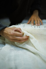 Obraz premium Close up of craftswoman fixing rug canvas on frame 