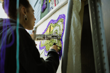 African american craftswoman making rug in workshop