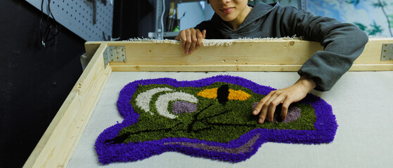 Web banner of african american craftswoman holding frame with handmade rug