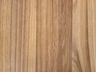 Close up of beige solid wood with dark veins texture. Bright natural brown wood with its typical veins. Seamless background texture