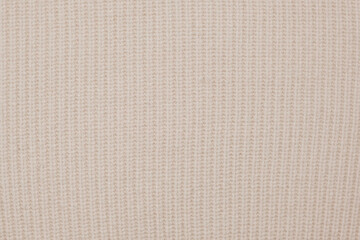 Soft Knitted Woolen Detailed Texture. Natural Fabric Closeup Knit Pattern. Beige Knitwear, Warm Cashmere Surface. Rotation, Macro. Cozy Creamy Textile Background. Clothes Production. Melange Yarn. 4K