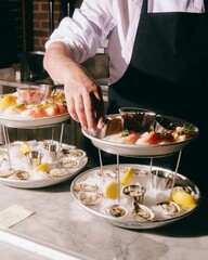 Chef arranging seafood platter in restaurant.