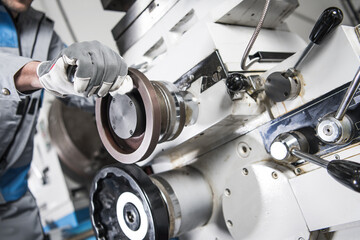Worker Operating Machinery in a Factory Setting Showing Precision Engineering Techniques
