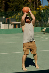 Middle-aged caucasian man playing basketball alone in the hotel of Turkey.