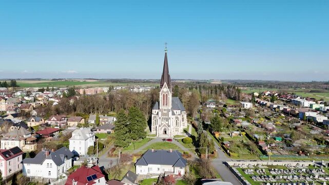 Aerial tracking orbit of Vitkov church complex and town under bright blue sky, Czech Republic