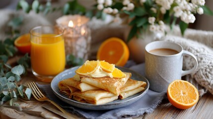 Delicious breakfast featuring pancakes, fresh orange juice, and coffee on a cozy table setting