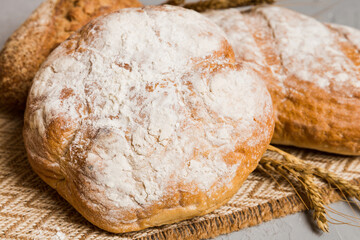 Homemade natural breads. Different kinds of fresh bread as background, perspective view with copy space